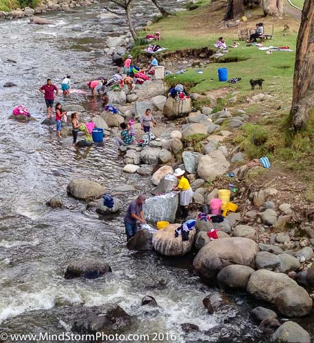 Ecuadorians washing clothes in river